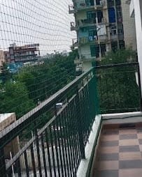Balcony netting across a high-rise opening