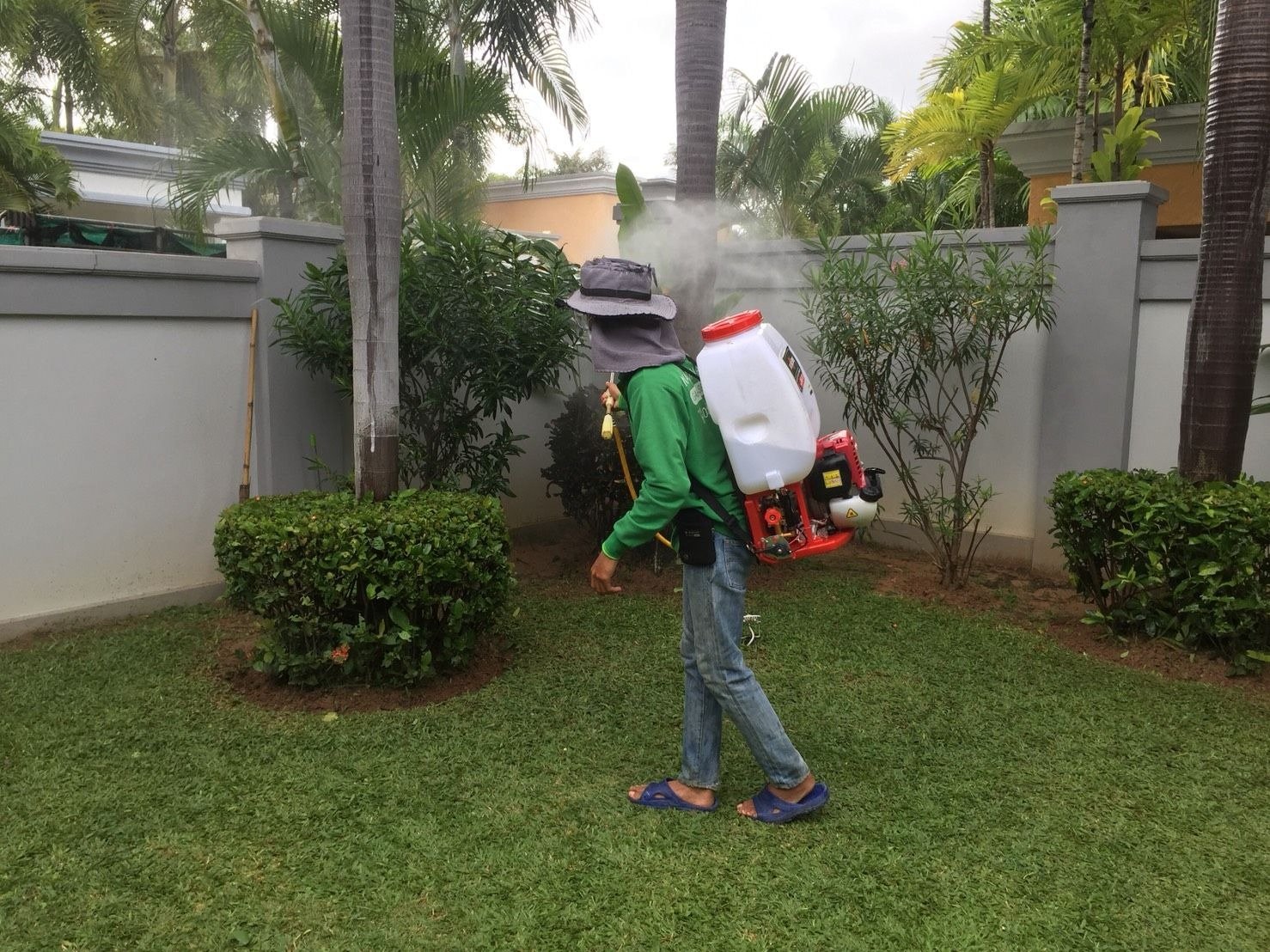Technician fogging an outdoor garden area