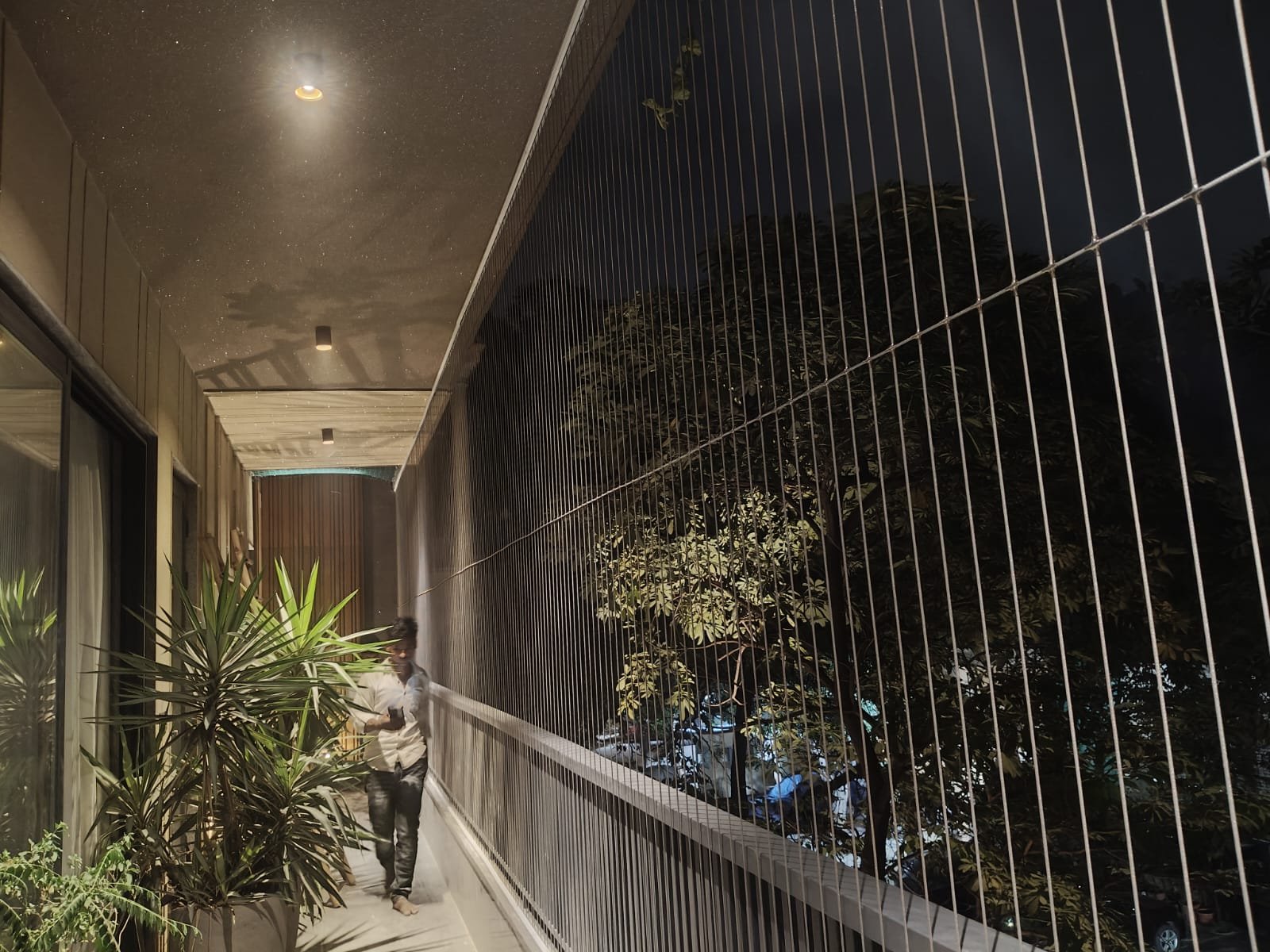 Vertical metal grill protecting an open residential corridor